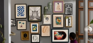 A collection of bestseller custom frames on a vibrant blue wall with decorative elements